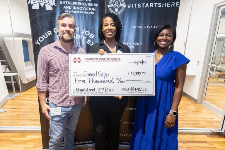 Trevor Acy and Tasha Bibb with a Dawg Tank winner in 2025